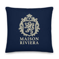 Navy blue pillow with gold crest and 'Maison Riviera' text on a white background
