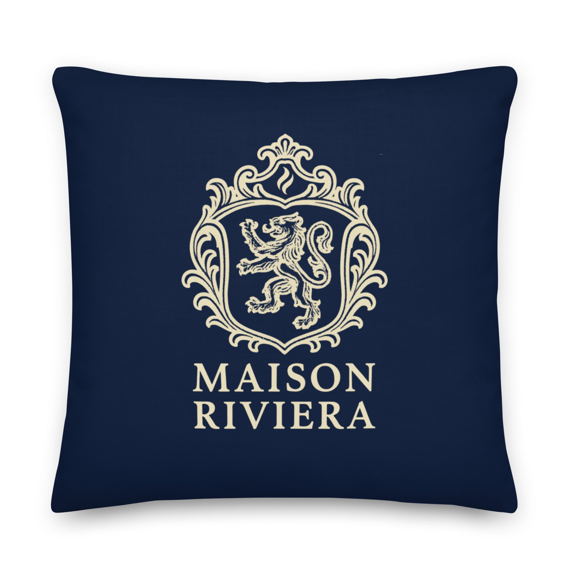 Navy blue pillow with gold crest and 'Maison Riviera' text on a white background