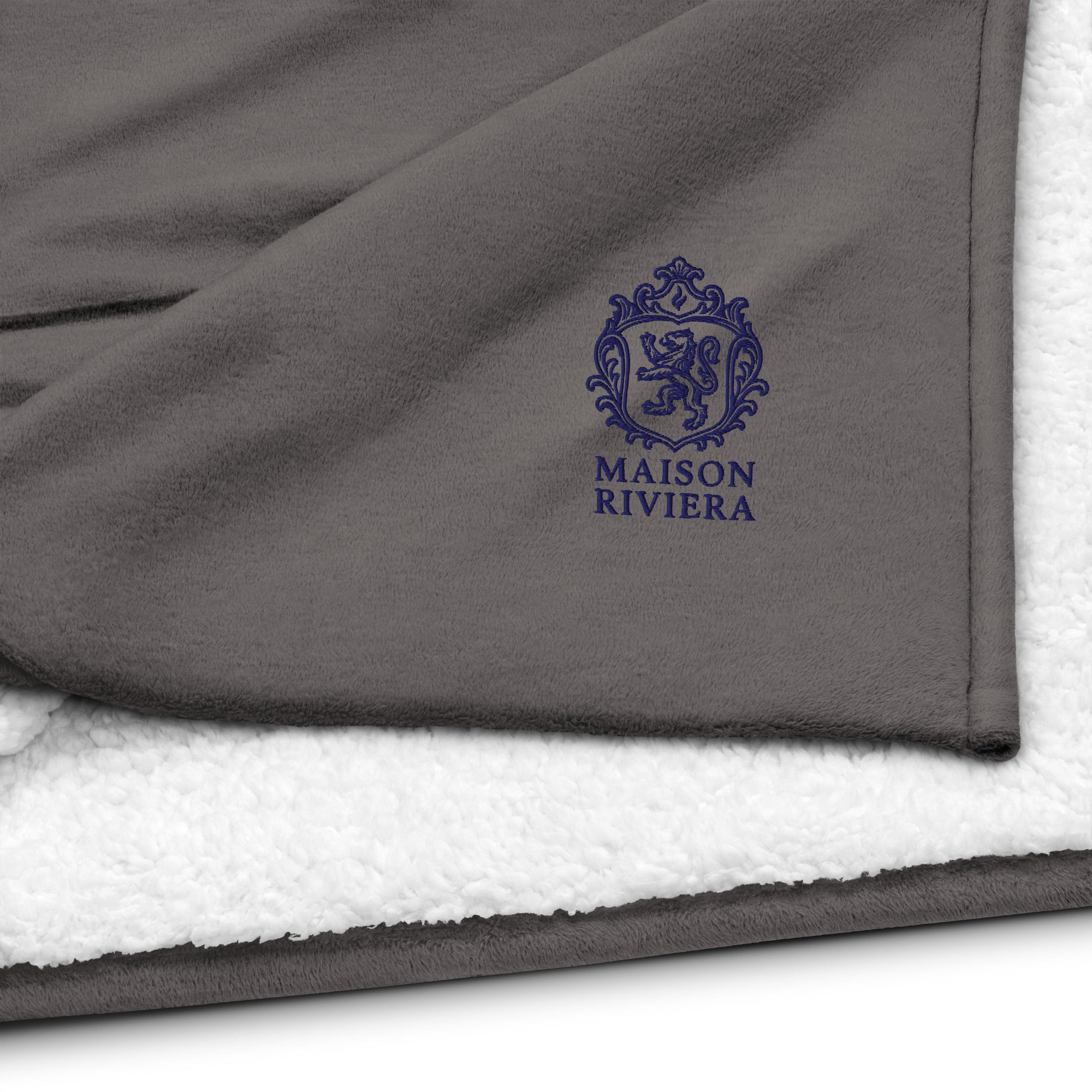 Gray and white blanket with Maison Riviera logo