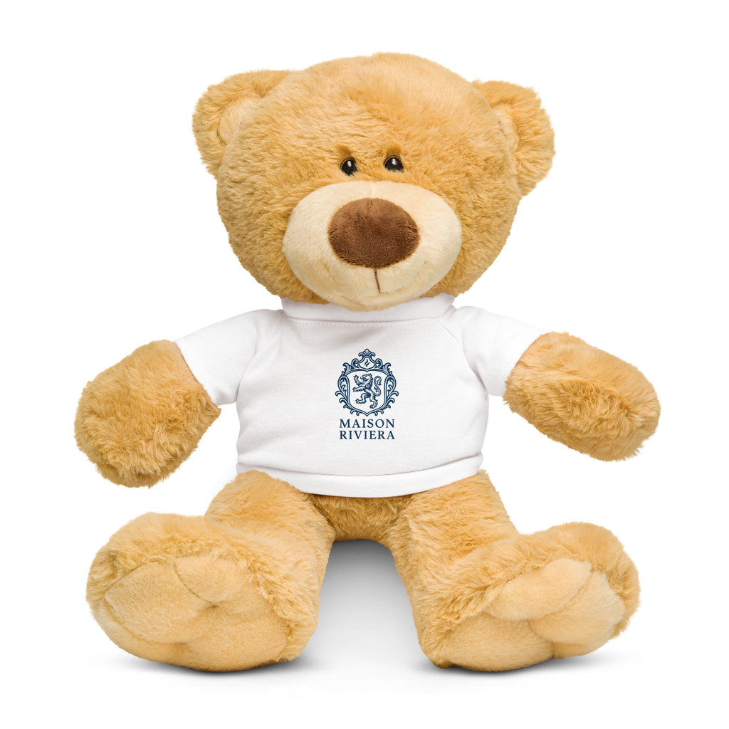 Teddy bear wearing a white shirt with Maison Riviera logo on a white background